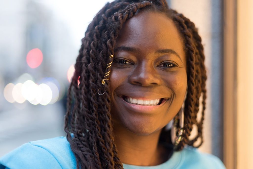 Woman sporting a side parted twist braided hairstyle